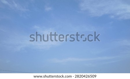 Clear Blue Sky Background with Soft Whispy White Cirrus Clouds