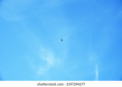 Clear Blue Sky With Cirrus Clouds, An Airplane Flies In The Sky. Selective Focus.