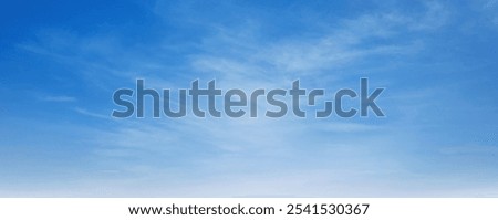 A clear blue sky with clouds. The sky is so clear that it looks like a painting