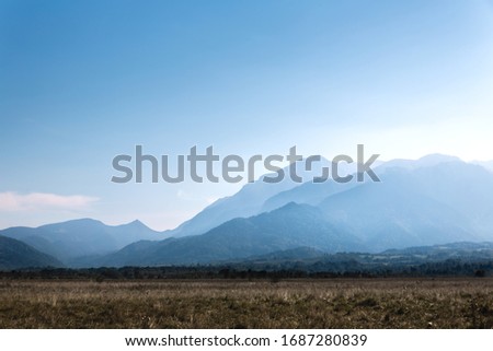 Clear blue sky with distant mountains of Romania 