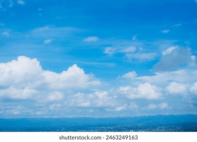 A clear blue sky with a few clouds. The sky is so clear that it almost looks like a painting