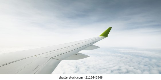 Clear blue sky and fluffy ornamental cumulus clouds  panoramic view from an airplane  wing close  up  Dreamlike cloudscape  Travel  tourism  vacations  weekend  freedom  peace  hope  heaven concepts