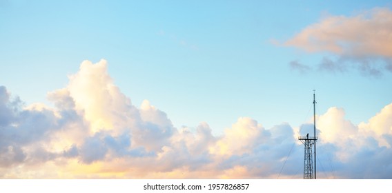 Clear blue sky with glowing pink and golden cumulus clouds after storm at sunset. Dramatic cloudscape. Concept art, meteorology, heaven, hope, peace, graphic resources, picturesque panoramic scenery