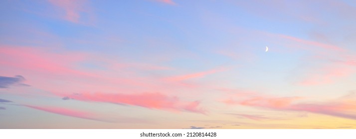 Clear blue sky, glowing pink and golden clouds after storm at sunset. Dramatic cloudscape. Moon, moonrise, midnight sun. Concept art, meteorology, heaven, hope, peace, picturesque panoramic scenery - Shutterstock ID 2120814428
