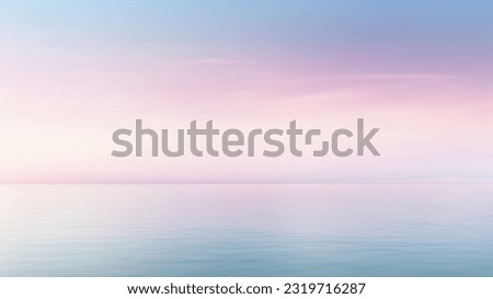 Clear blue sky sunset with glowing pink and purple horizon on calm ocean seascape background. Picturesque