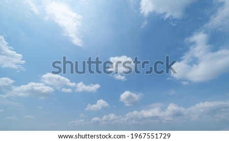 Clear blue sky with white fluffy clouds at noon. Day time. Abstract nature landscape background.