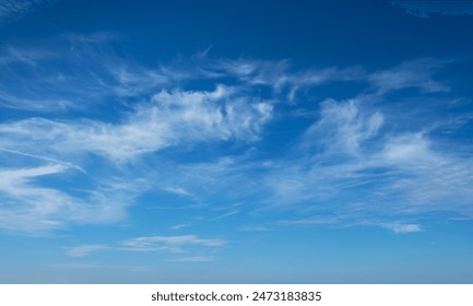 Clear Blue Sky with Wispy Clouds on a Sunny Day - Nature, Weather, and Serenity - Powered by Shutterstock