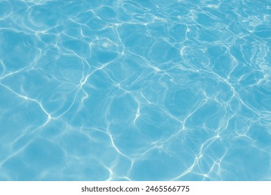 Clear blue swimming pool water with sunlight reflections creating abstract patterns and ripples.
 - Powered by Shutterstock