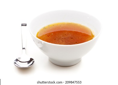 Clear Broth With Spoons Next To It