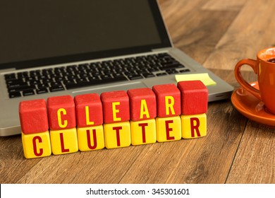 Clear Clutter Written On A Wooden Cube In A Office Desk