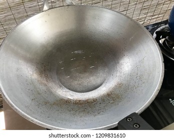 Clear Coconut Oil Cooking On The Silver Wok.