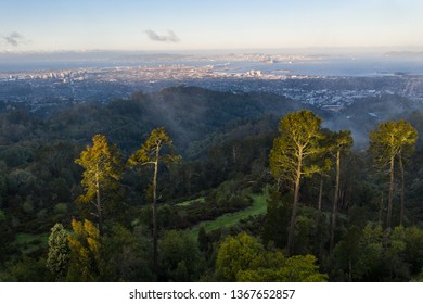 A clear, colorful dawn breaks over the East Bay hills and the cities of Oakland and Berkeley in the San Francisco Bay area of Northern California.