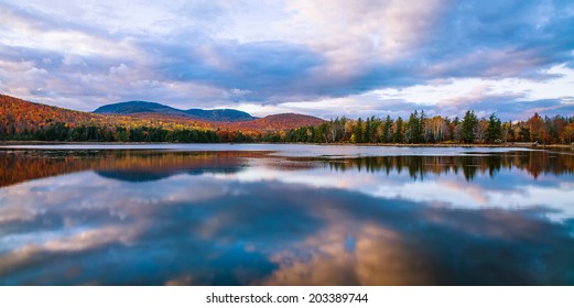 A Clear Colorful Reflection On An Autumn Evening At Loon Lake In The Adirondack Mountains Of New York State, USA