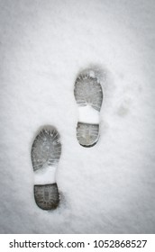 
Clear Deep Footprints On White Winter Snow Of A Pair Of Boots,track In Snow, Overhead View. Texture Of Snow Surface