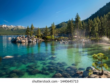 Clear Emerald Water With Rocks, Pine Trees And Mountains At Sand Harbor SP, Lake Tahoe, Nevada