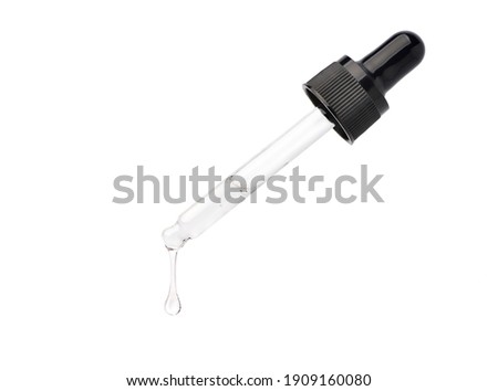 Clear essential serum oil dripping from dropper  isolated on white background. Clipping path.