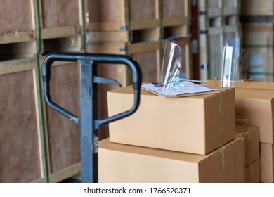 Clear Face Shield On Parcel Cardboard On Hand Lift In Warehouse, Protection Virus Equipment For Workman In Industry.