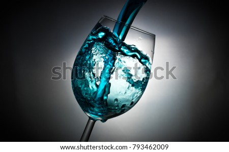 
?rystal clear glass with blue liquid in action. 