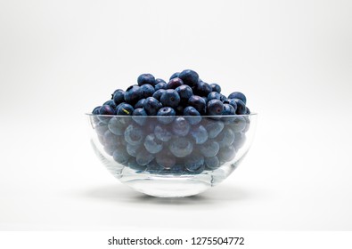 clear glass bowl full of ripe blueberries isolated on white - Powered by Shutterstock