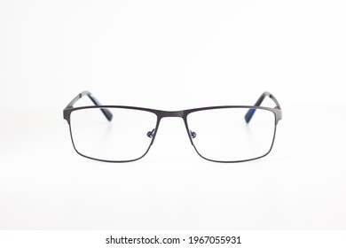 Clear Glass Eyeglasses With Thin Metal Frame Close Up Shot Isolated On White Background Shallow Depth Of Field.