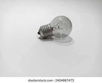 a clear glass light bulb, on a white background  - Powered by Shutterstock