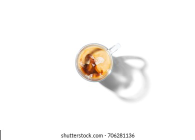 Clear Glass Mug With Coffee And Creamer In Top Down View Isolated On A White Background