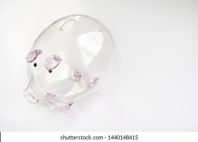 Clear Glass Piggy Bank On White Background 