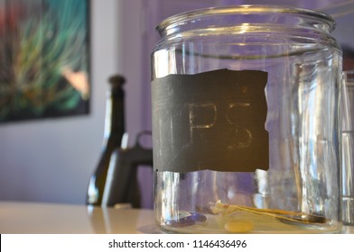 Clear Glass Tip Jar On A Counter