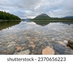 Clear lake with rock bottom. Hardenburg Bay on Lake Clark, Alaska. Tanalian Mountain reflected on water. Port Alsworth in Lake Clark National Park and Preserve. 