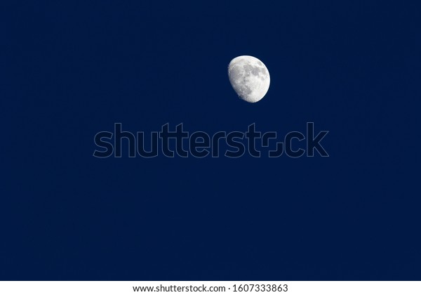 Clear moon and\
moon phase on blue sky\
background