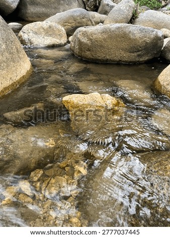 Clear Mountain Stream Flowing Over Rocks with Natural Ripples and Fresh Water Texture