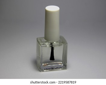 Clear Nail Polish Bottle For Top Coat On Simple Background.