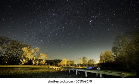 A Clear Night Sky Above A Nicely Lit Dock In East Texas Along Caddo Lake