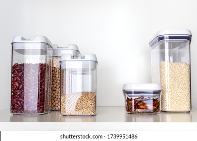Clear Pantry Containers Filled with Non-Perishable Foods-- Dried Beans, Grains, Dried Peppers, Rice