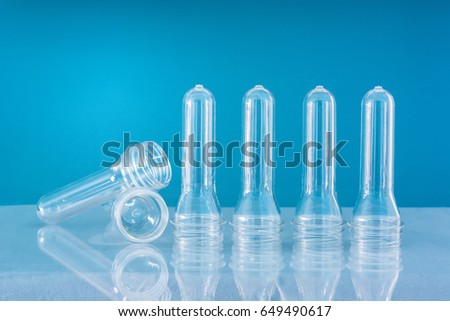 Clear PET Preforms on sky blue background for presentation