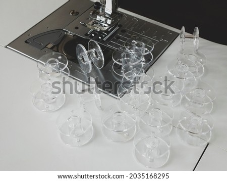 Clear plastic bobbins for sewing machine. A lot of empty spools for thread. Sewing accessories