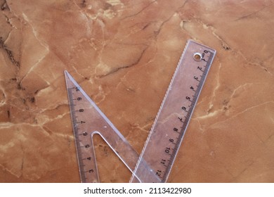 Clear Plastic Ruler On A Marble Ceramic Background