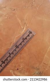 Clear Plastic Ruler On A Marble Ceramic Background