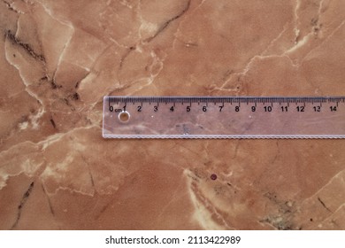 Clear Plastic Ruler On A Marble Ceramic Background