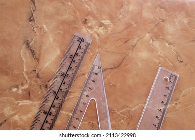 Clear Plastic Ruler On A Marble Ceramic Background