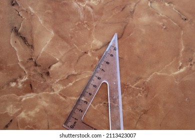 Clear Plastic Ruler On A Marble Ceramic Background