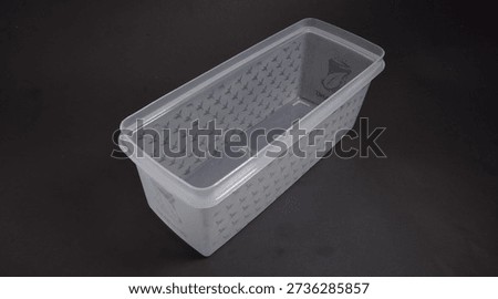 clear plastic storage box rectangular shape, black background