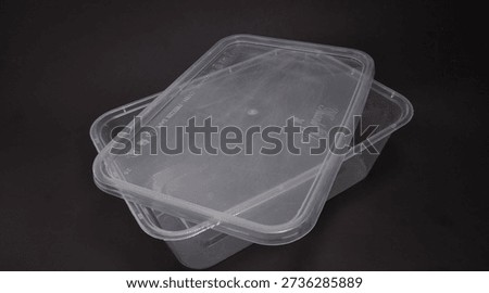 clear plastic storage box rectangular shape, black background