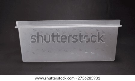 clear plastic storage box rectangular shape, black background