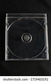 Clear Retro CD Cases With No Compact Discs Against A Black Background