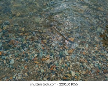 Clear River Water Above Stones Lying Beneath