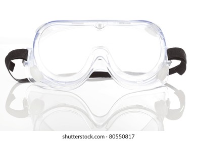 Clear safety glasses against a white background