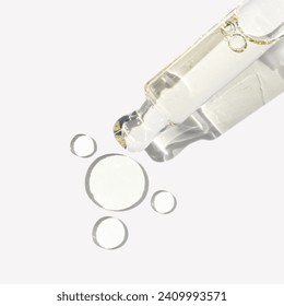 Clear serum in glass dropper with texture drops on white background - Powered by Shutterstock