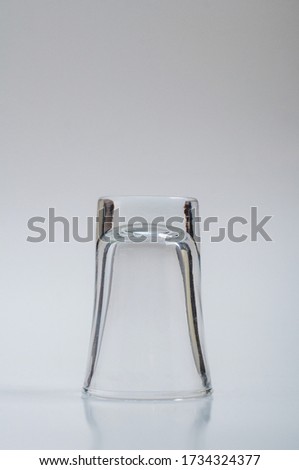 clear shot glass upside down on a white background