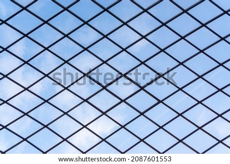 Clear sky seen through the barbed wire fence